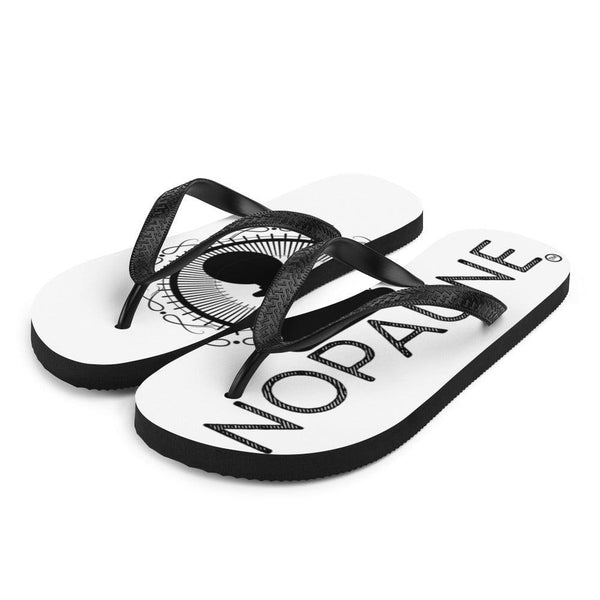 A pair of white flip-flops with black toe straps, facing the camera at an angle. The word "Nopaune" is printed on the left flip-flop, and the Nopaune symbol(a chess pawn with a "not allowed sign" laid over it, surrounded by spokes/rays and broken infinity signs) can be seen on the right flip-flop.
