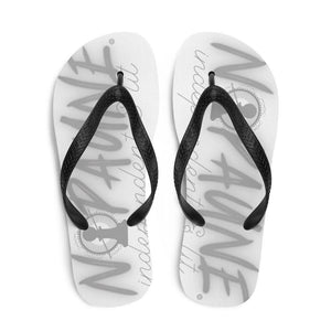 Overhead shot of white flip-flops with black toe straps. The words "Nopaune. Independent & Lit" are printed on both flip-flops. The letter O in "Nopaune" has been replaced with the Nopaune logo (a chess pawn with a "not allowed sign" laid over it, surrounded by spokes/rays and broken infinity signs).